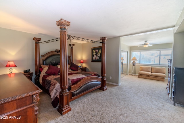 carpeted bedroom featuring ceiling fan, baseboards, and ornate columns
