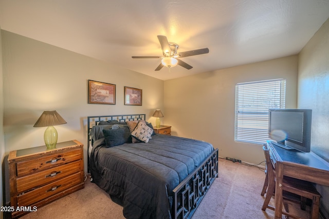 bedroom featuring light colored carpet and ceiling fan