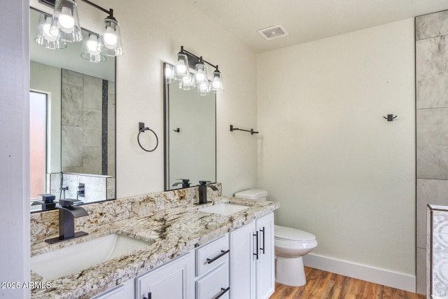 bathroom with hardwood / wood-style flooring, toilet, and vanity