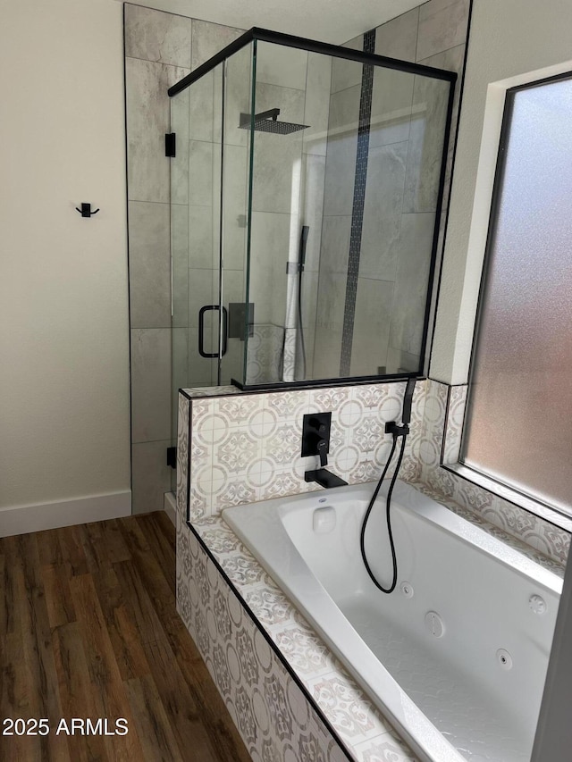 bathroom featuring wood-type flooring and separate shower and tub