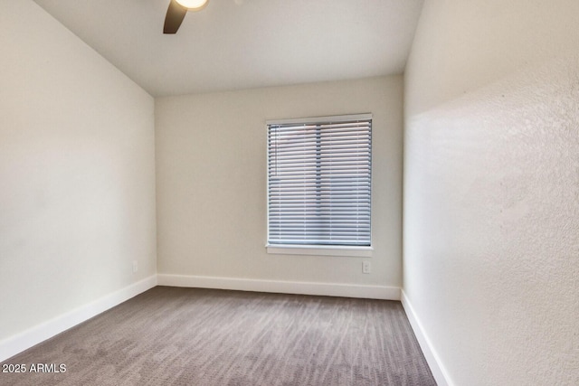 carpeted spare room featuring ceiling fan