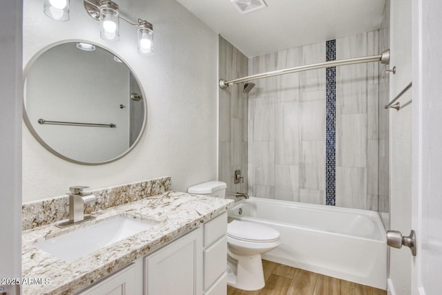 full bathroom with tub / shower combination, wood-type flooring, toilet, and vanity