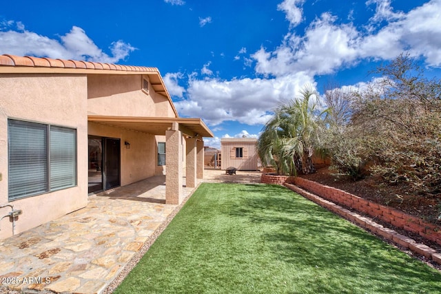 view of yard with a patio area and a storage shed