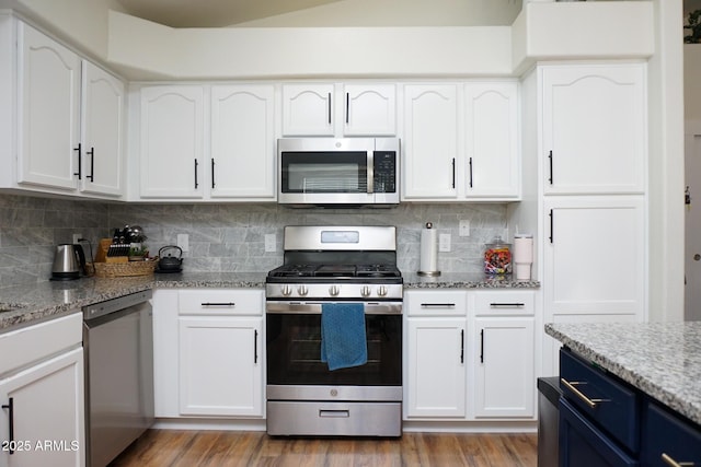 kitchen featuring light stone countertops, white cabinets, and appliances with stainless steel finishes