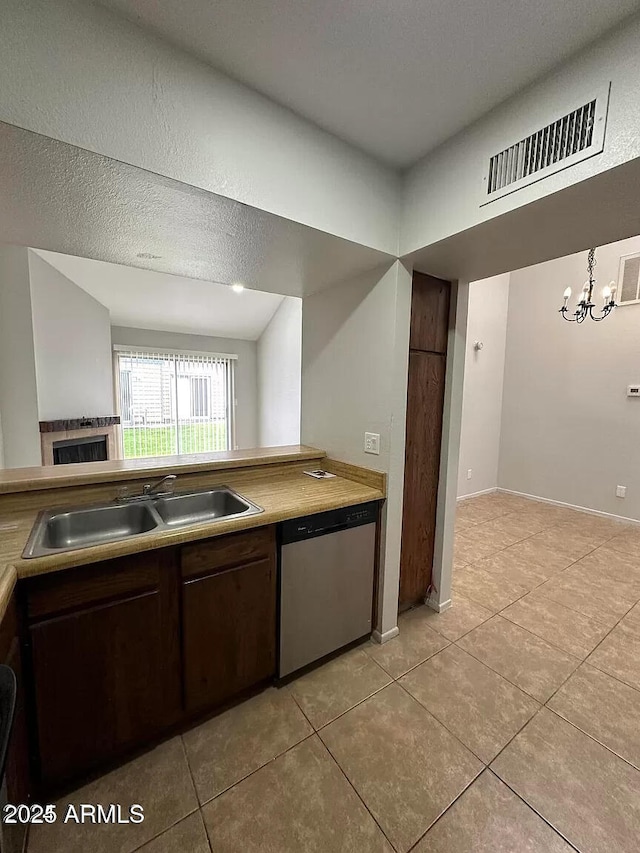 14002 N 49th Ave Unit 1120, Glendale, AZ 85306 - kitchen with stainless steel dishwasher, a sink, light tile patterned flooring, and dark brown cabinets