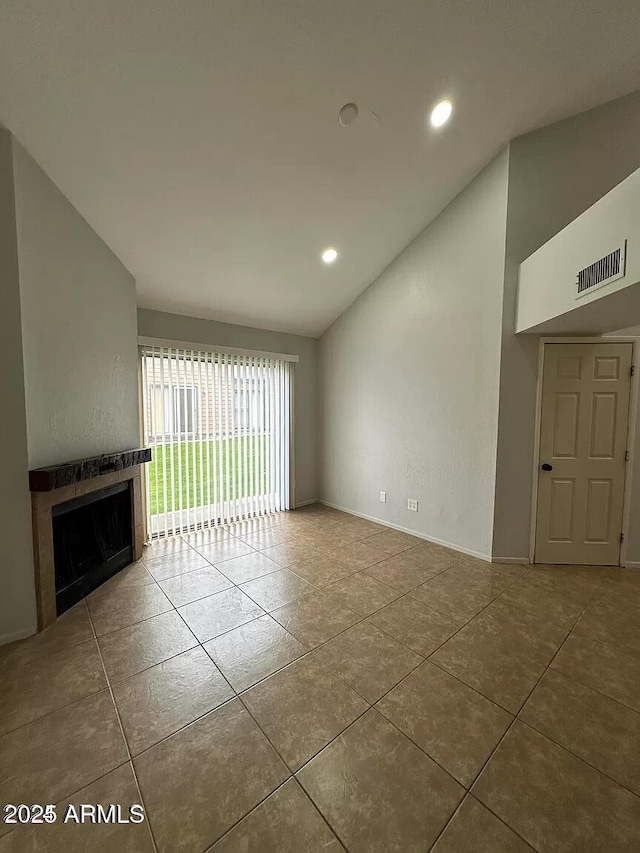 14002 N 49th Ave Unit 1120, Glendale, AZ 85306 - unfurnished living room with a tile fireplace, tile patterned flooring, recessed lighting, lofted ceiling, and baseboards