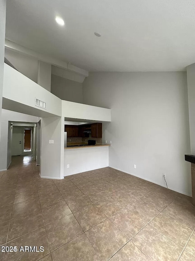 14002 N 49th Ave Unit 1120, Glendale, AZ 85306 - unfurnished living room with tile patterned floors and high vaulted ceiling