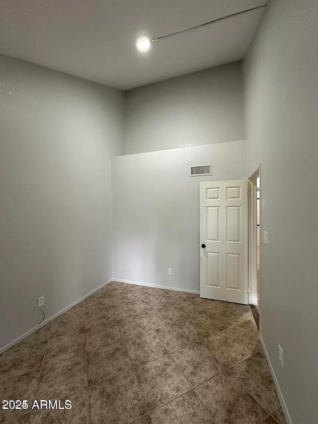 14002 N 49th Ave Unit 1120, Glendale, AZ 85306 - unfurnished room with a high ceiling, tile patterned flooring, and baseboards