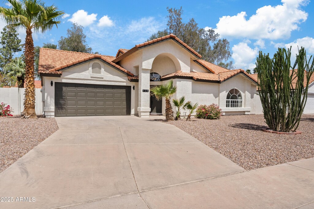 438 E Hackamore St, Mesa, AZ 85203 - mediterranean / spanish-style house featuring driveway, stucco siding, a tiled roof, and a garage