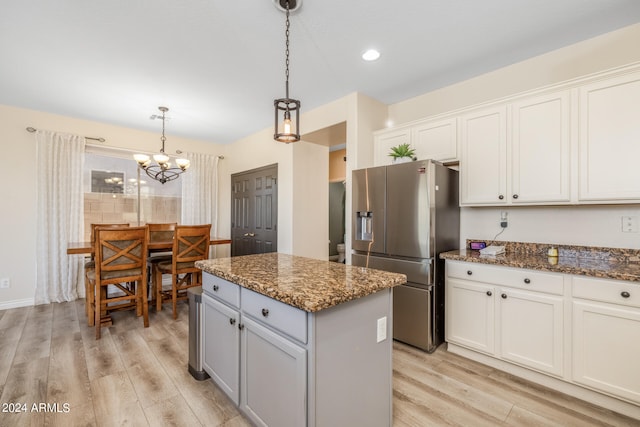 kitchen featuring a center island, white cabinetry, light hardwood / wood-style flooring, decorative light fixtures, and stainless steel refrigerator with ice dispenser