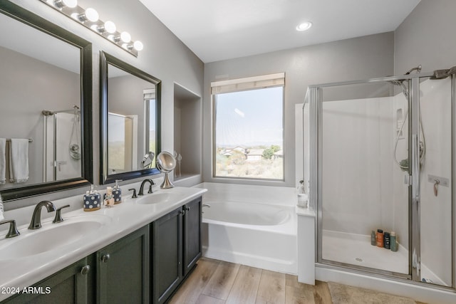 bathroom featuring wood-type flooring, vanity, and independent shower and bath