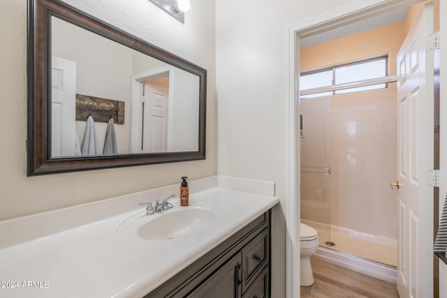 bathroom featuring vanity, hardwood / wood-style floors, toilet, and an enclosed shower