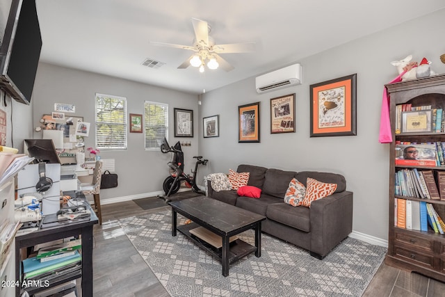 living room featuring ceiling fan, dark wood-type flooring, and a wall mounted AC