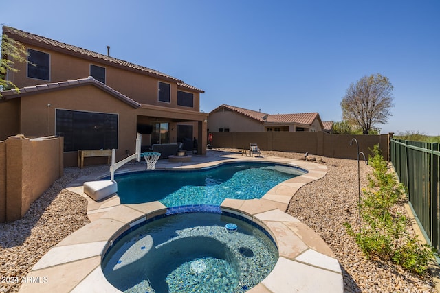 view of pool featuring an in ground hot tub and a patio