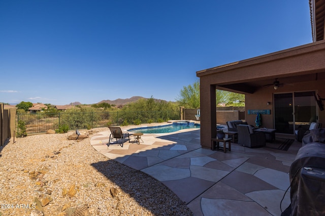 view of patio / terrace with ceiling fan, a mountain view, a fenced in pool, and outdoor lounge area