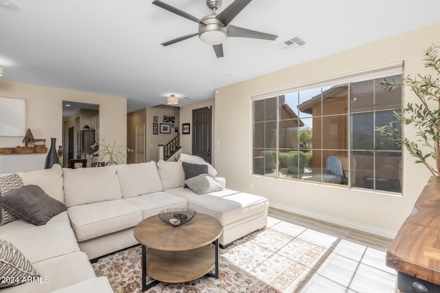 living room with ceiling fan and light hardwood / wood-style flooring