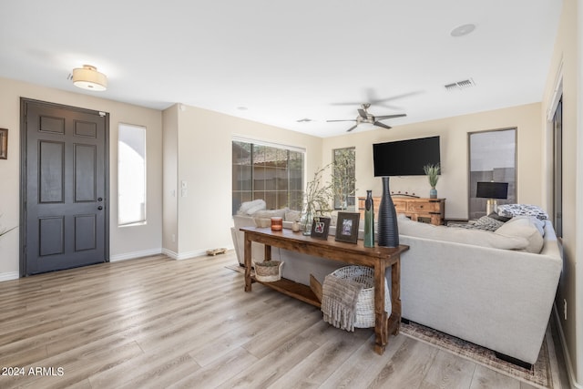 living room featuring light wood-type flooring and ceiling fan