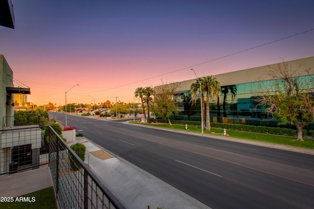 view of road with curbs, street lights, and sidewalks