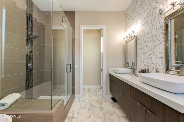 bathroom featuring a sink, baseboards, a shower stall, and marble finish floor