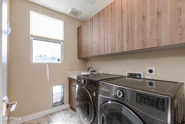 laundry room featuring visible vents, marble finish floor, baseboards, cabinet space, and independent washer and dryer