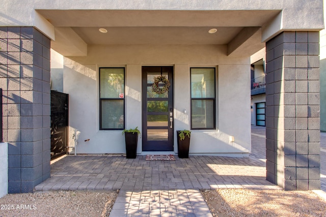 view of exterior entry featuring stucco siding