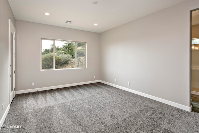 empty room featuring dark carpet