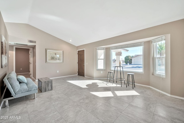 living room featuring light tile patterned floors and lofted ceiling