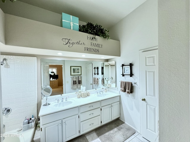 bathroom with dual sinks, oversized vanity, and tile flooring