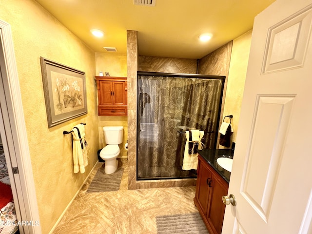 bathroom featuring vanity, tile floors, a shower with shower door, and toilet