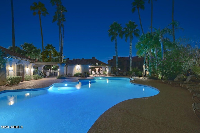 pool at twilight with a patio