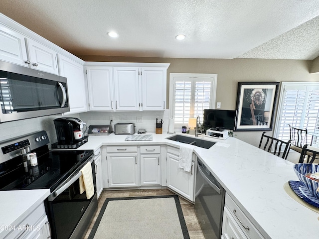 kitchen featuring white cabinetry, appliances with stainless steel finishes, and sink