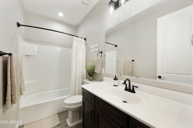 bathroom featuring wood finished floors, vanity, shower / bath combination with curtain, toilet, and visible vents