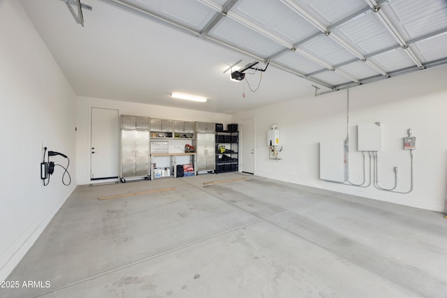 garage featuring water heater and a garage door opener