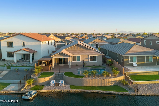 back of house with a patio area, a fenced backyard, and a residential view