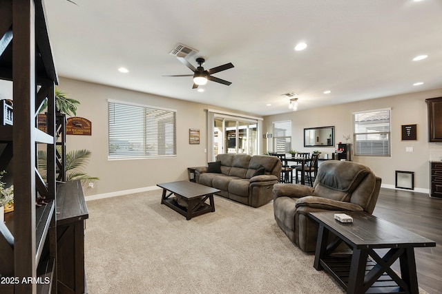 living area featuring recessed lighting, visible vents, a ceiling fan, and baseboards