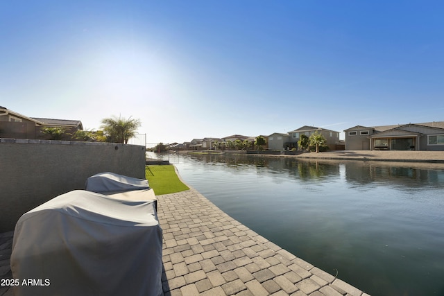 dock area featuring a residential view and a water view