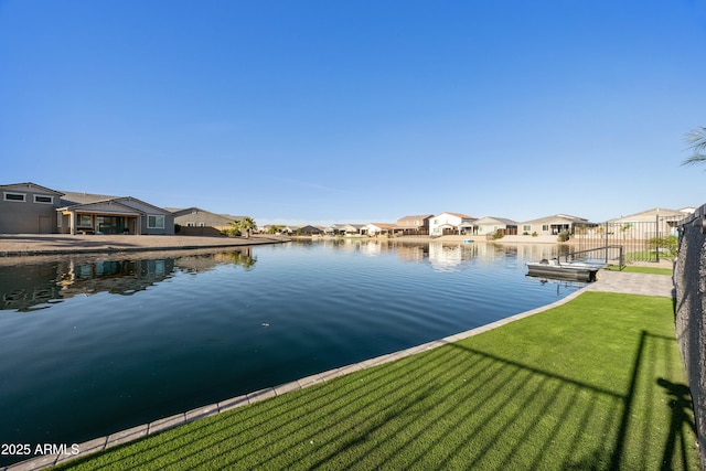 water view featuring fence and a residential view