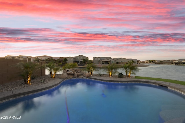 pool featuring fence and a residential view