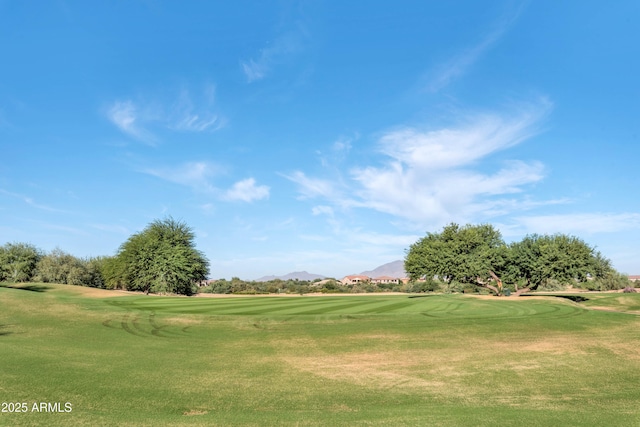 view of community with a lawn, a mountain view, and golf course view