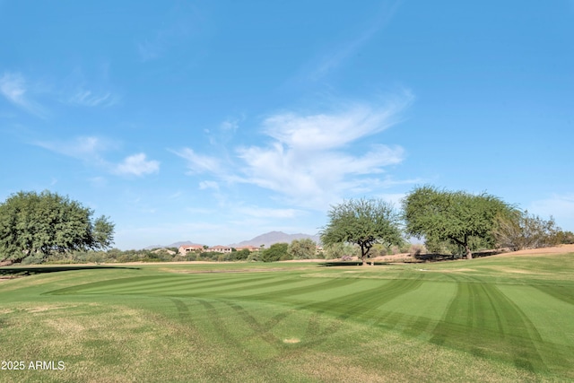 view of home's community featuring a yard, a mountain view, and golf course view