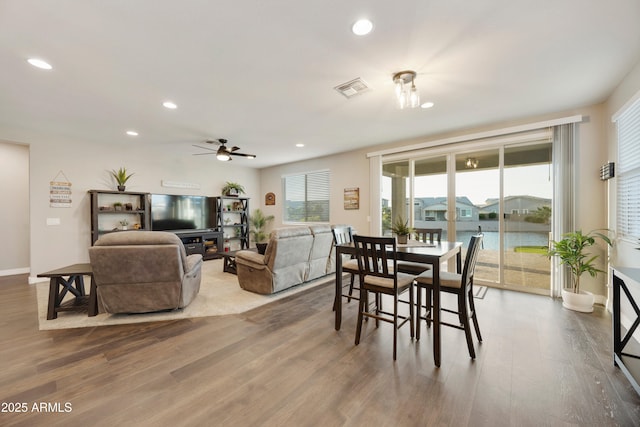 dining space with visible vents, a ceiling fan, wood finished floors, and recessed lighting