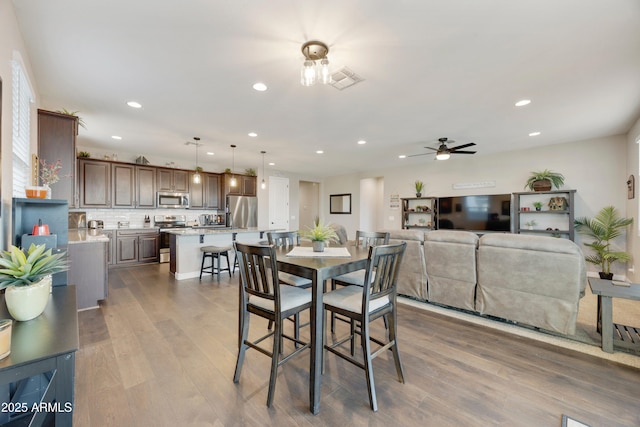 dining area featuring visible vents, a ceiling fan, wood finished floors, and recessed lighting
