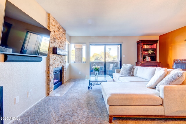 carpeted living room featuring a large fireplace