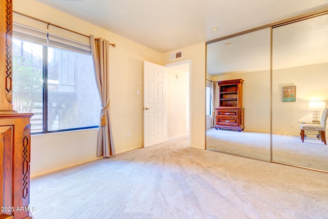 unfurnished bedroom featuring a closet and carpet