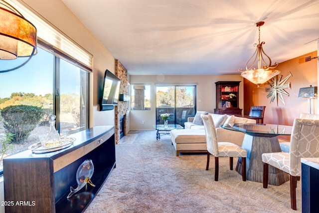 living room featuring a stone fireplace and light colored carpet