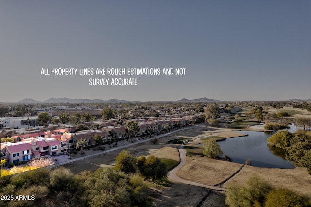 birds eye view of property featuring a water and mountain view