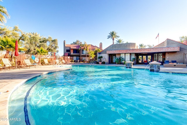 view of swimming pool with a patio and pool water feature