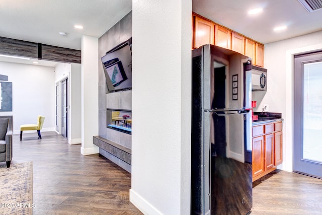 kitchen featuring hardwood / wood-style floors and black appliances