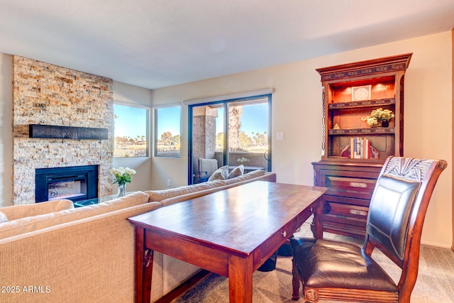 carpeted dining space with a fireplace