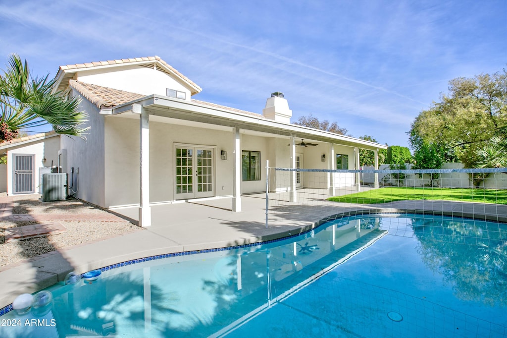 view of pool with ceiling fan, cooling unit, and a patio